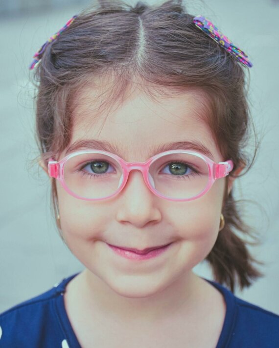 Photo of a cute toddler girl with glasses